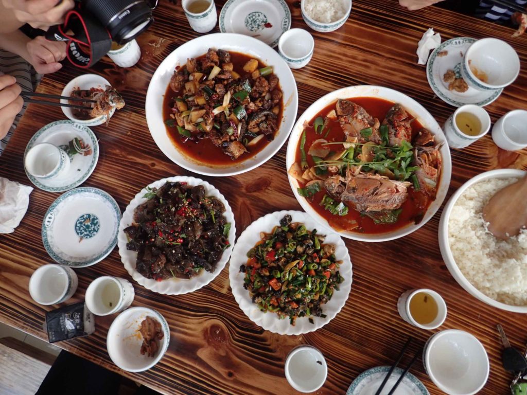 Lunch. There was Kung Pao chicken (the closest thing I can compare it to), cave fungus with chilli, limpets/barnacles (with chilli and vegetables) and whole braised lake fish (…with chilli)