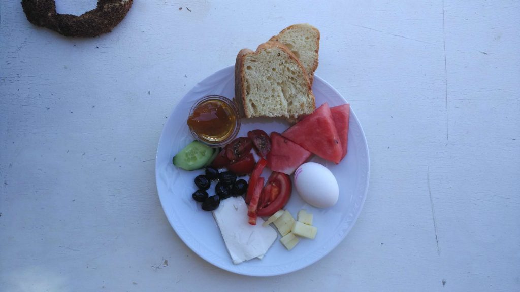 A typical Turkish breakfast. Cheese, bread, fresh fruit and vegetables, eggs, and jam