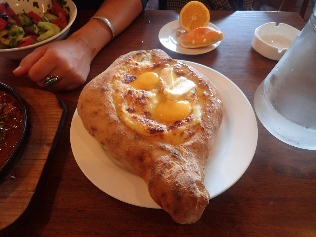 Acharuli khachapuri: a boat of freshly baked bread filled with Georgian cheese (similar to feta), egg yolks, and butter. You mix it all together, then tear off the bread and dip in the mixture, fondue-style