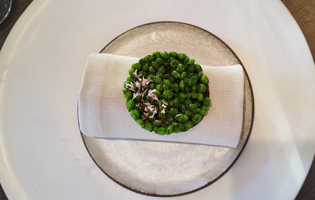 Crisp of wild roses and Danish peas. Delicate and cruncy, the peas were individually peeled by the interns upstairs. The husks are used to make one of the juice courses.